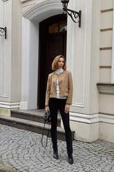 a lady in a wool jacket and a pair of black pants